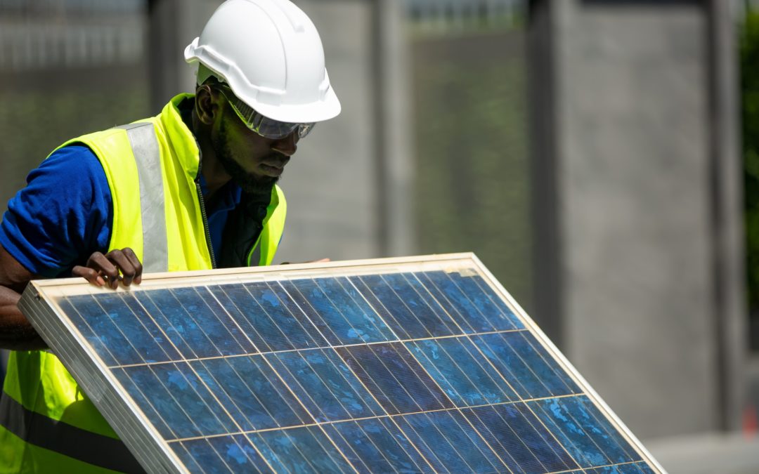 Construction worker performing analysis on solar panels.