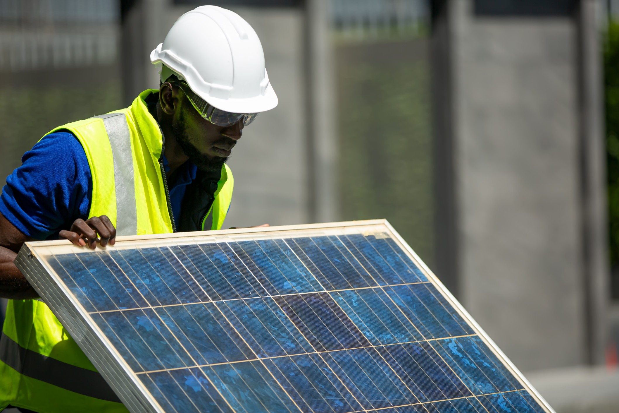 Construction worker performing analysis on solar panels.